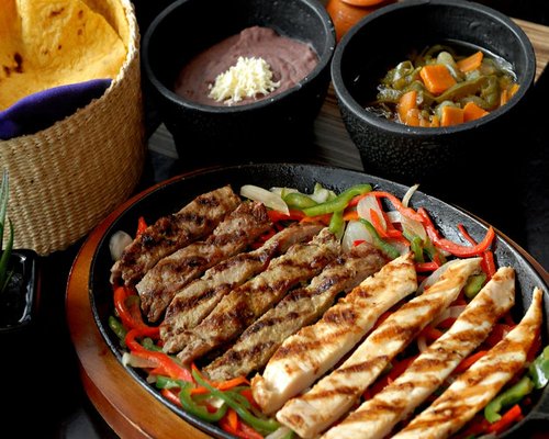 Soft corn tortillas folded over chicken and nopales cactus