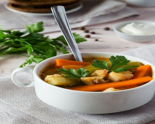 A comforting bowl of traditional vegetable soup with carrots and potatoes