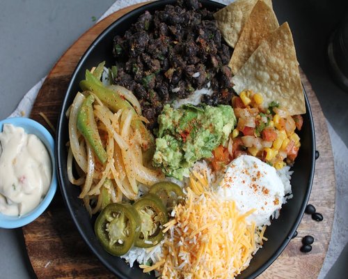 Bowl of Mexican style rice and beans garnished with fresh avocado